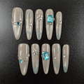 51 - Noah-UlightBlue glitter oval nails with aqua rhinestones and star-shaped gems