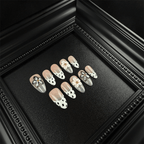 Almond cow print press-on nails with 3D pink flowers