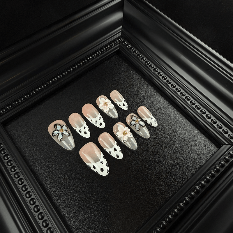 Almond cow print press-on nails with 3D pink flowers