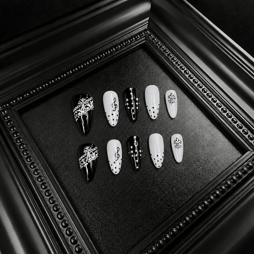 Black and white almond nails with lace and treble clef details