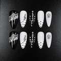 Black and white almond press-on nails with music note design