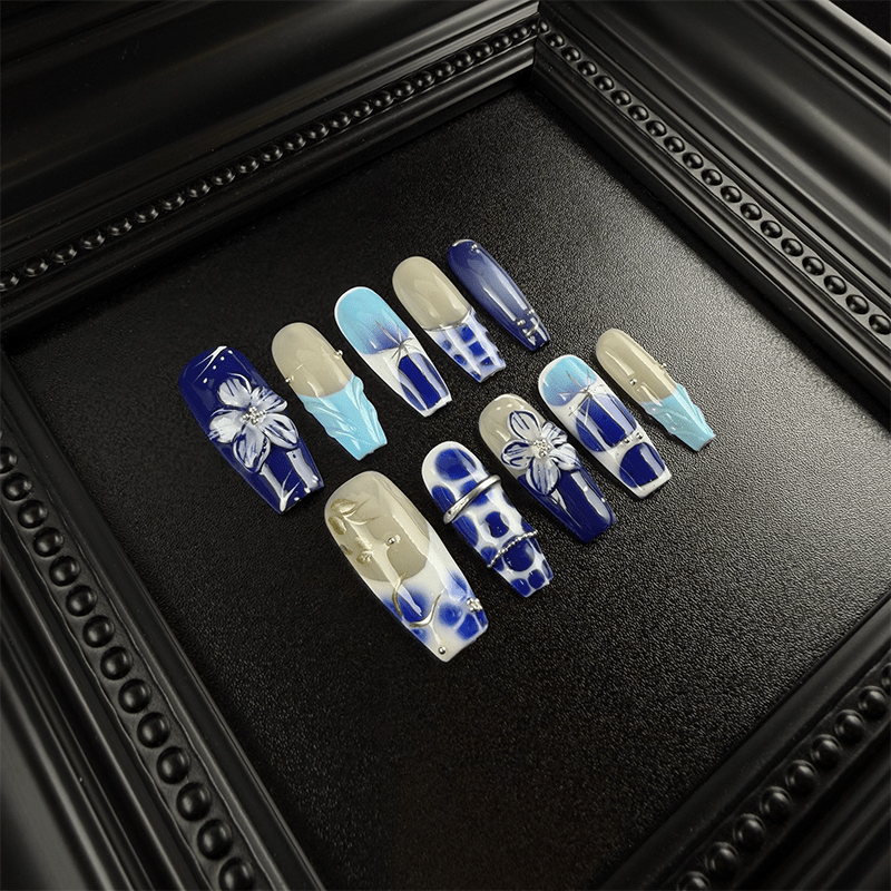 Hand-painted 3D floral details on blue and white press-on nails