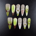 Matcha green stiletto press-on nails with floral details